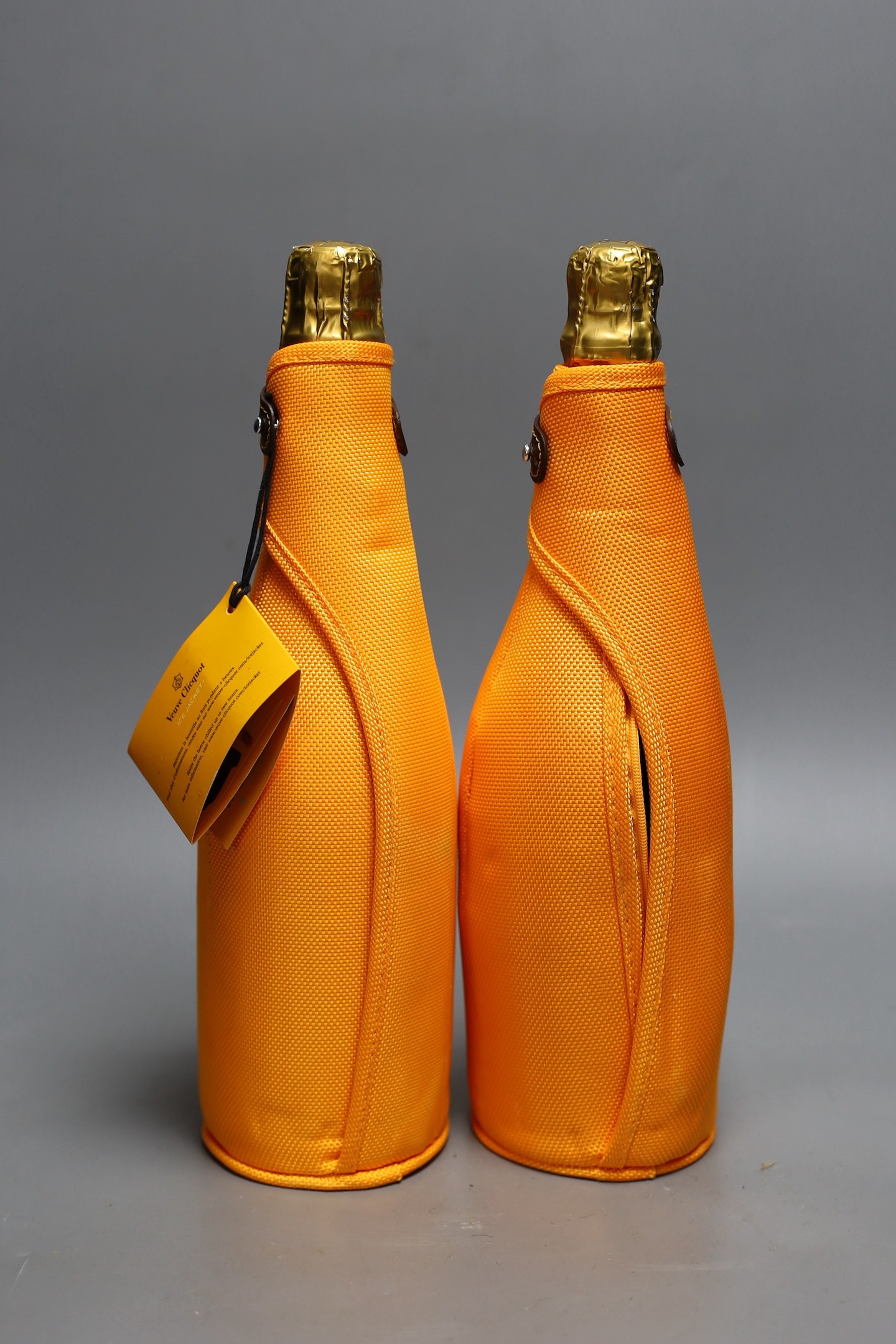 Two bottles of Veuve Cliquot champagne with ice jackets